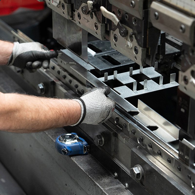 Operator setting up tooling on the press brake