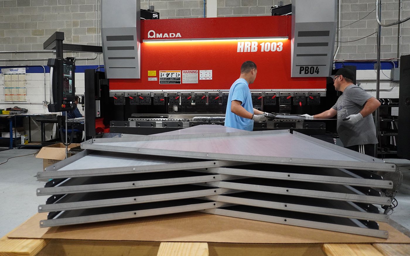 FABMAX team handling large formed panels on the production floor